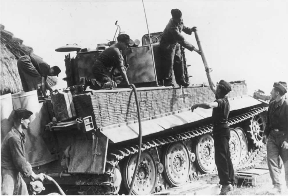 German tankers refuel a Tiger I tank of Heavy-Panzer-Battalion 509 and load ammunition inside the compartment, Lublin area, July 1944.