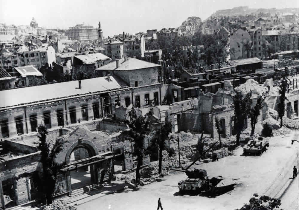 A destroyed Soviet T-34-85 tank and a destroyed German StuG III assult gun in front of the ruins of Deli railway terminal in Budapest, summer of 1946.