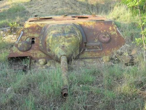 A partially rusted Jagdpanzer IV tank destroyer dug in the ground, formerly used as a pillbox at the Bulgarian-Turkish border.