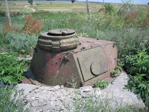 A semi-rusted Pz IV tank turret dug in the ground, formerly used as a pillbox at the Bulgarian-Turkish border.