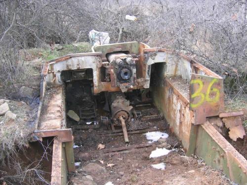 A rusted hull of a Stug III assault gun dug in the ground, formerly used as a pillbox at the Bulgarian-Turkish border.